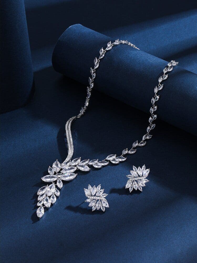 Diamond necklace and earring set on deep blue velvet